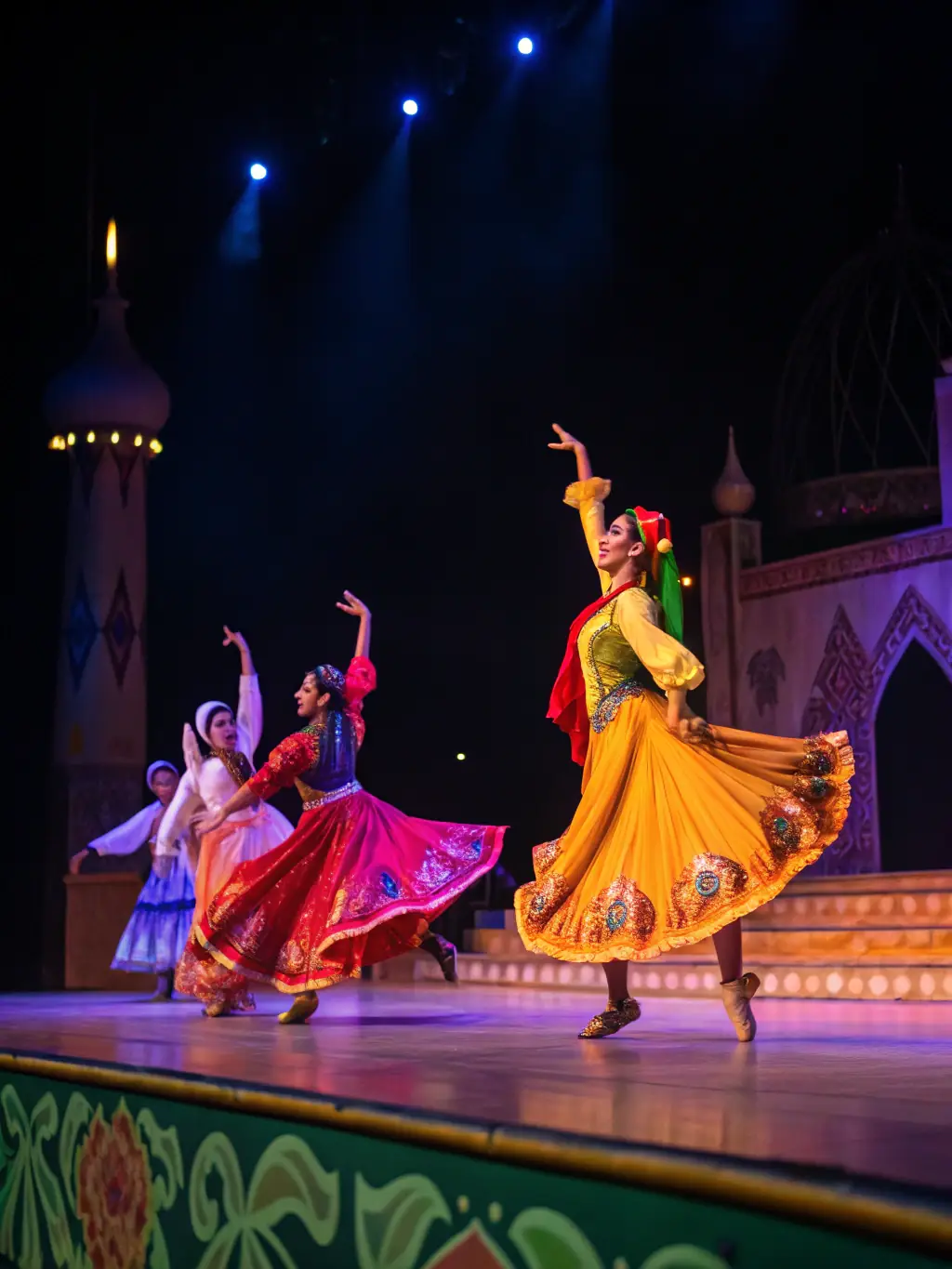 A photograph showcasing a cultural performance organized by LE PACHYDERME CULTUREL, featuring dancers in traditional attire on a vibrant stage.